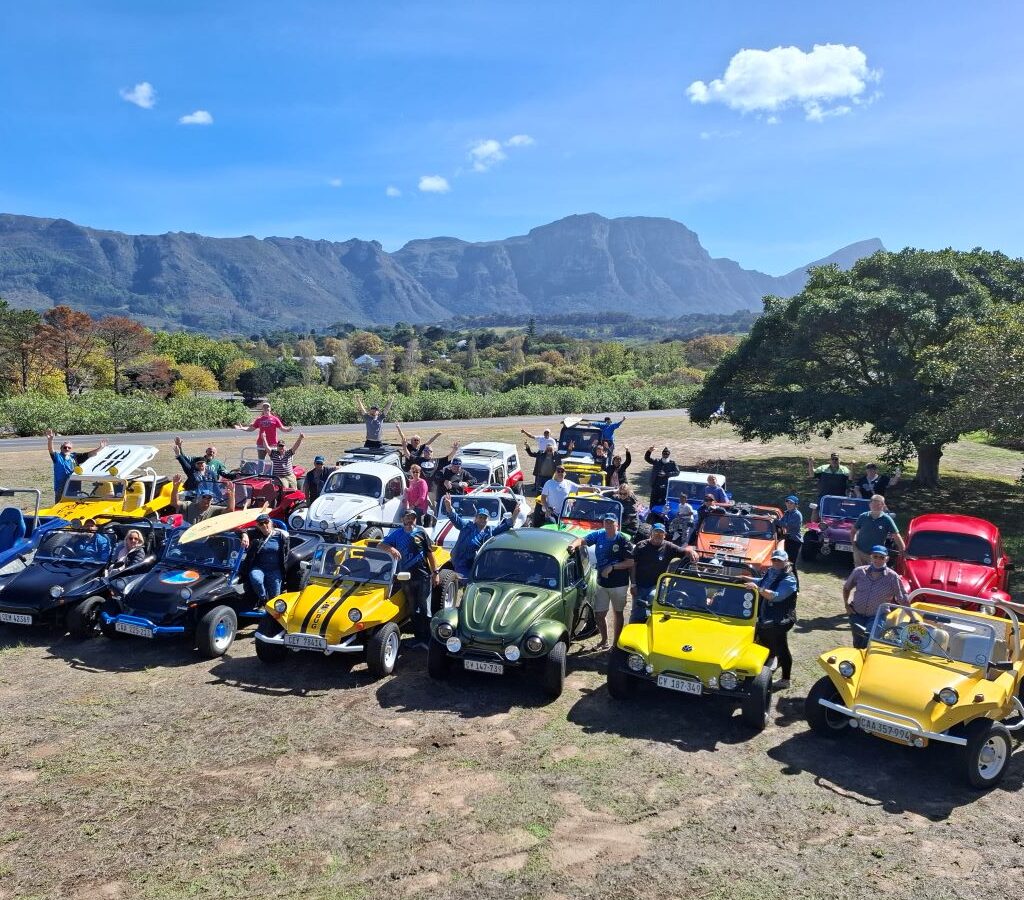 A few classic beach buggies lined up at a watering hole during the Cape Buggy Tour 2025, capturing memories.