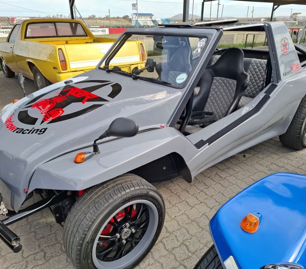 Rico Barlow's grey Kango beach buggy, proudly displaying "Rico Barlow Racing," at the Wild Buggers Reach for a Dream charity run.
