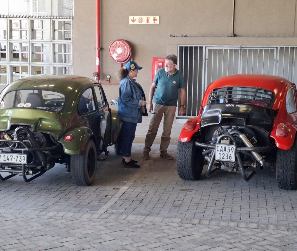 James and Mickey, owners of two Baja Bugs, sharing stories during a pitstop on the Cape Buggy Tour 2025.