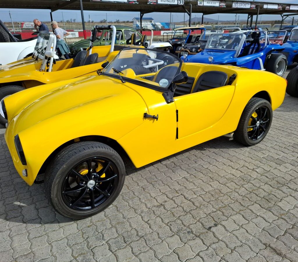 A vibrant yellow beach buggy kit car of unknown make, showcased at the Wild Buggers Reach for a Dream charity run.