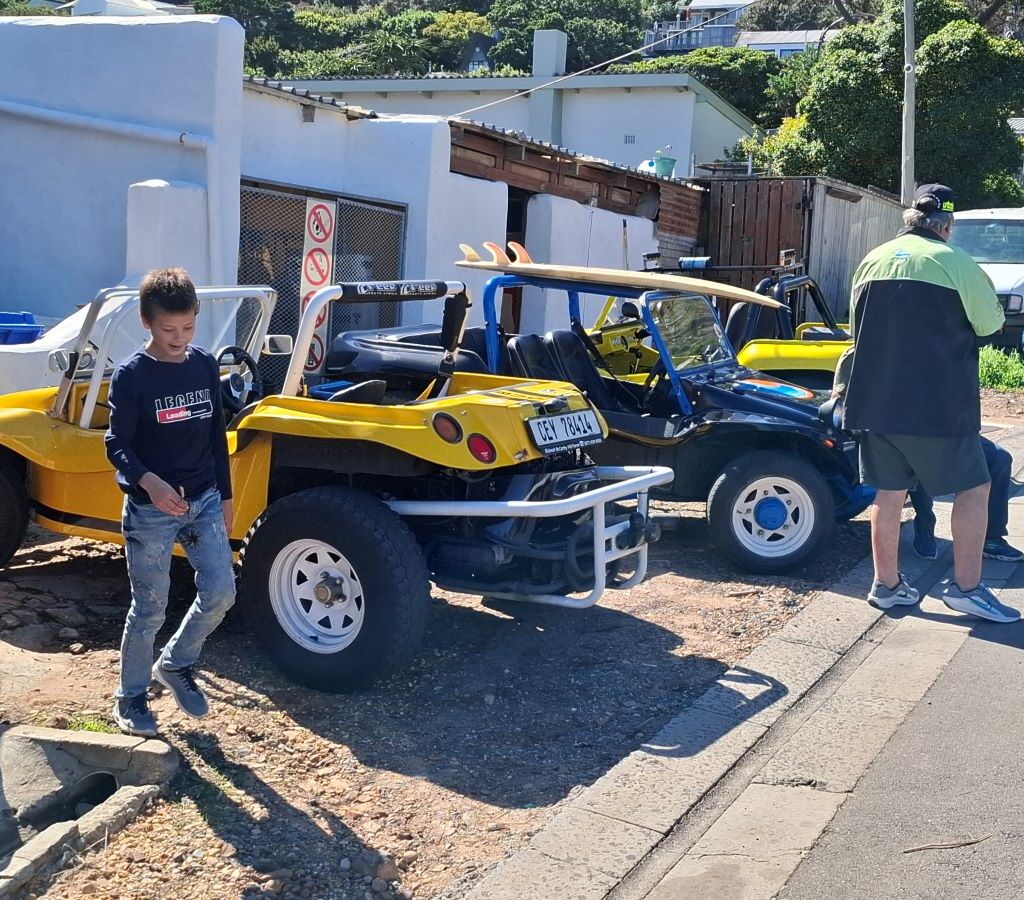 Beach buggies and club members posing while a photographer captures the Cape Buggy Tour 2025.