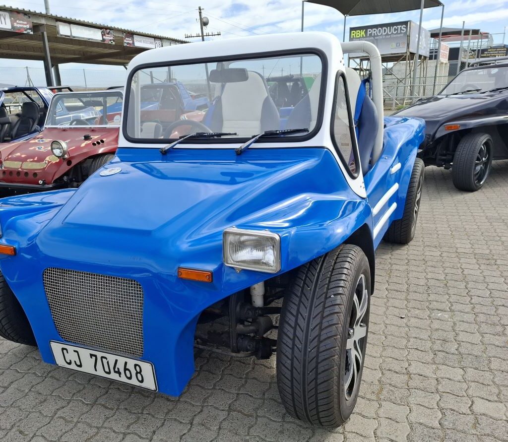 A blue Kestrel KartKraft beach buggy featuring a front-mounted radiator at the Wild Buggers Reach for a Dream charity run, suggesting a non-air-cooled engine.