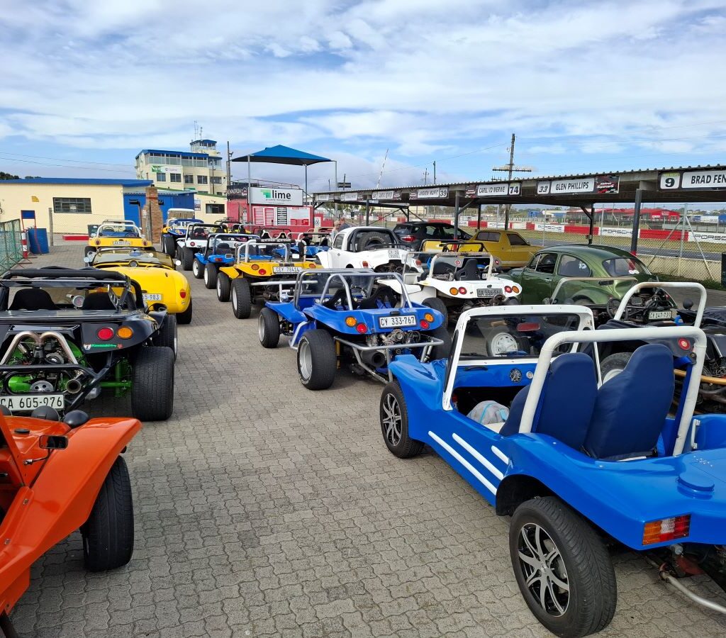 A vibrant line-up of various beach buggies parked at the gate of Killarney International Raceway, ready for the Reach for a Dream children to choose their rides.