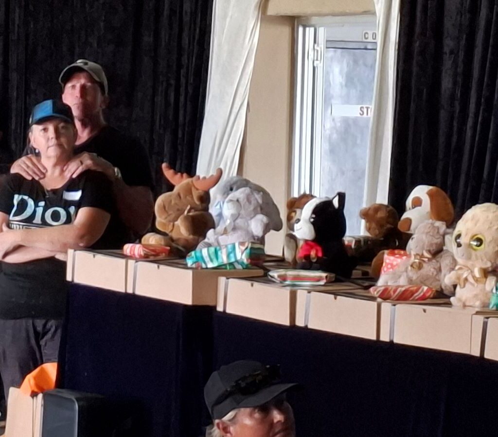 Inside the Killarney clubhouse, speeches are being given and personalized gifts from Saint and Bloom are being handed out to the Reach for a Dream children during the Wild Buggers charity run.
