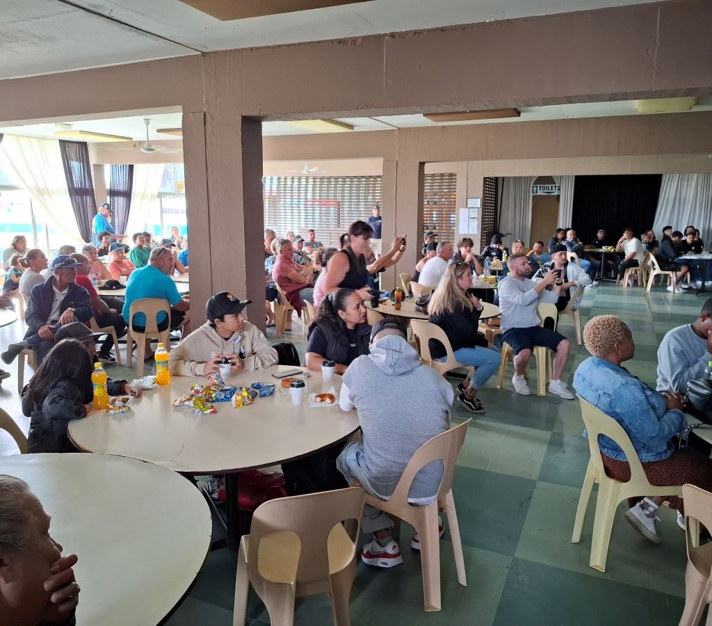 Inside the Killarney clubhouse, parents of the Reach for a Dream children and Wild Buggers Beach Buggy Club members are observing the gift-giving and speeches.