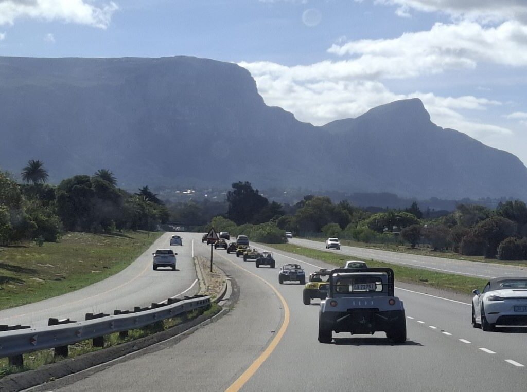 A convoy of beach buggies cruising the scenic route during the Cape Buggy Tour 2025, embodying the spirit of adventure.