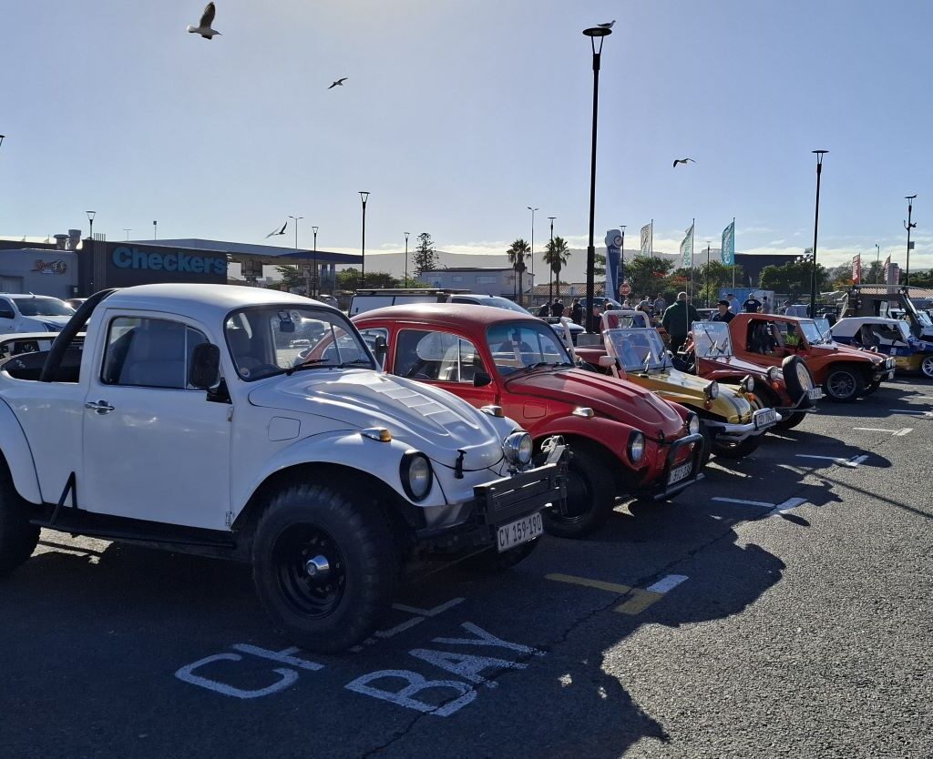 Line of beach buggies at the Cape Buggy Tour 2025 starting point in Bothasig, showcasing classic VW and fiberglass styles.