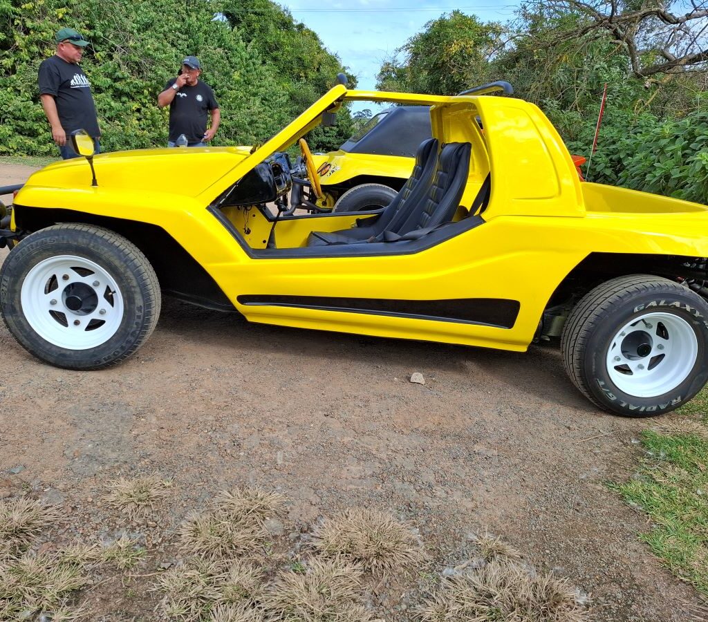 A bright yellow Kango beach buggy with a 1600 VW Beetle motor, showcasing its vibrant color and open-top design.
