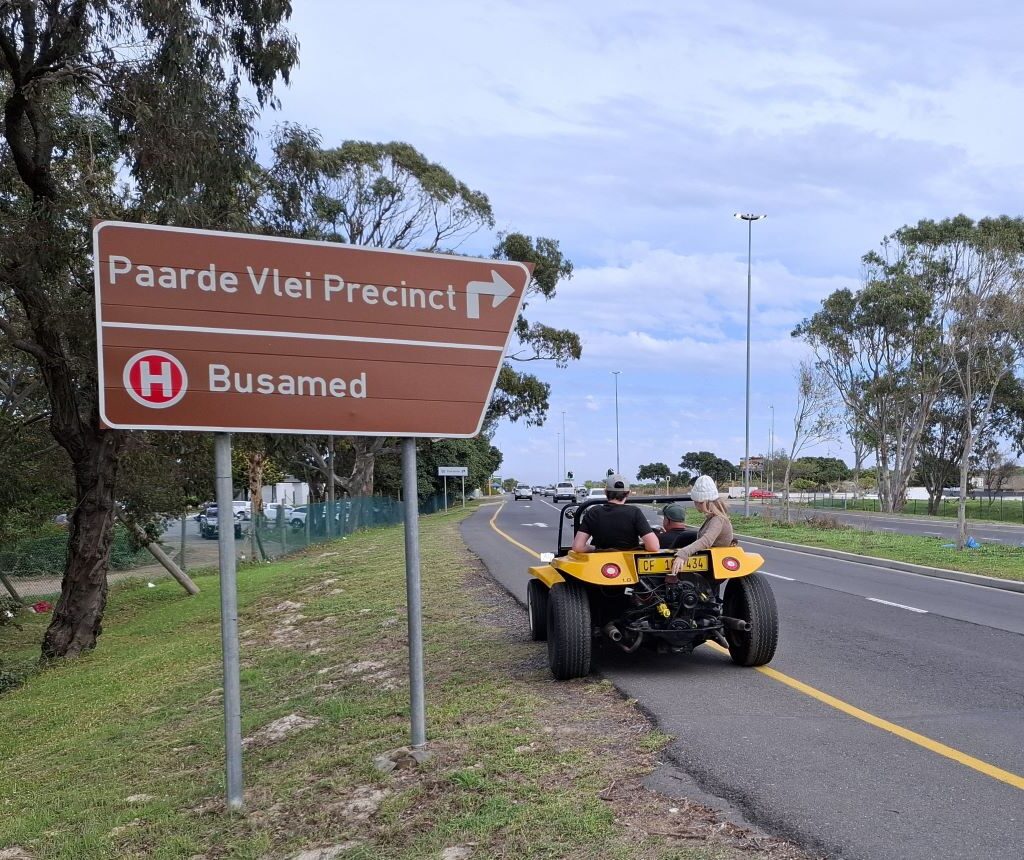 A yellow Beamish beach buggy is parked on the side of a road, during Wiehann's Run.