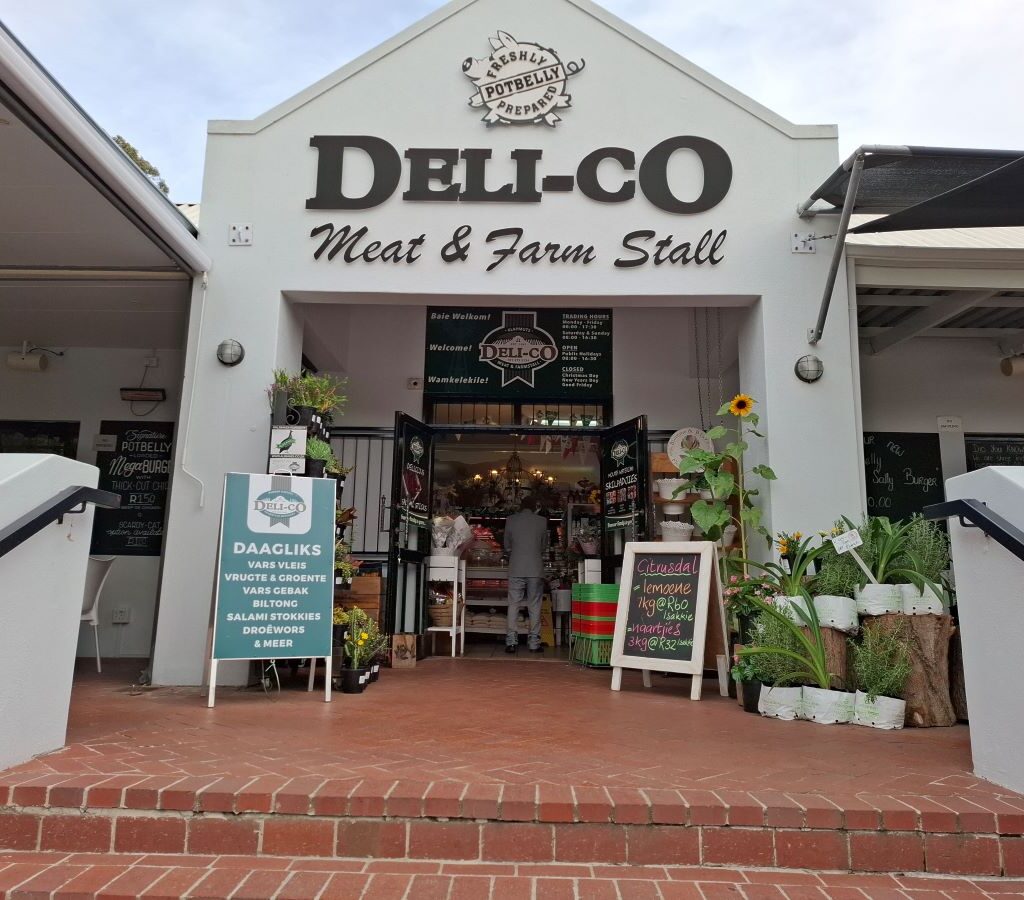 The welcoming main entrance of Potbelly Pantry in Klapmuts, featuring its distinctive signage, rustic architecture, where the Wild Buggers' beach buggy club made a pitstop.