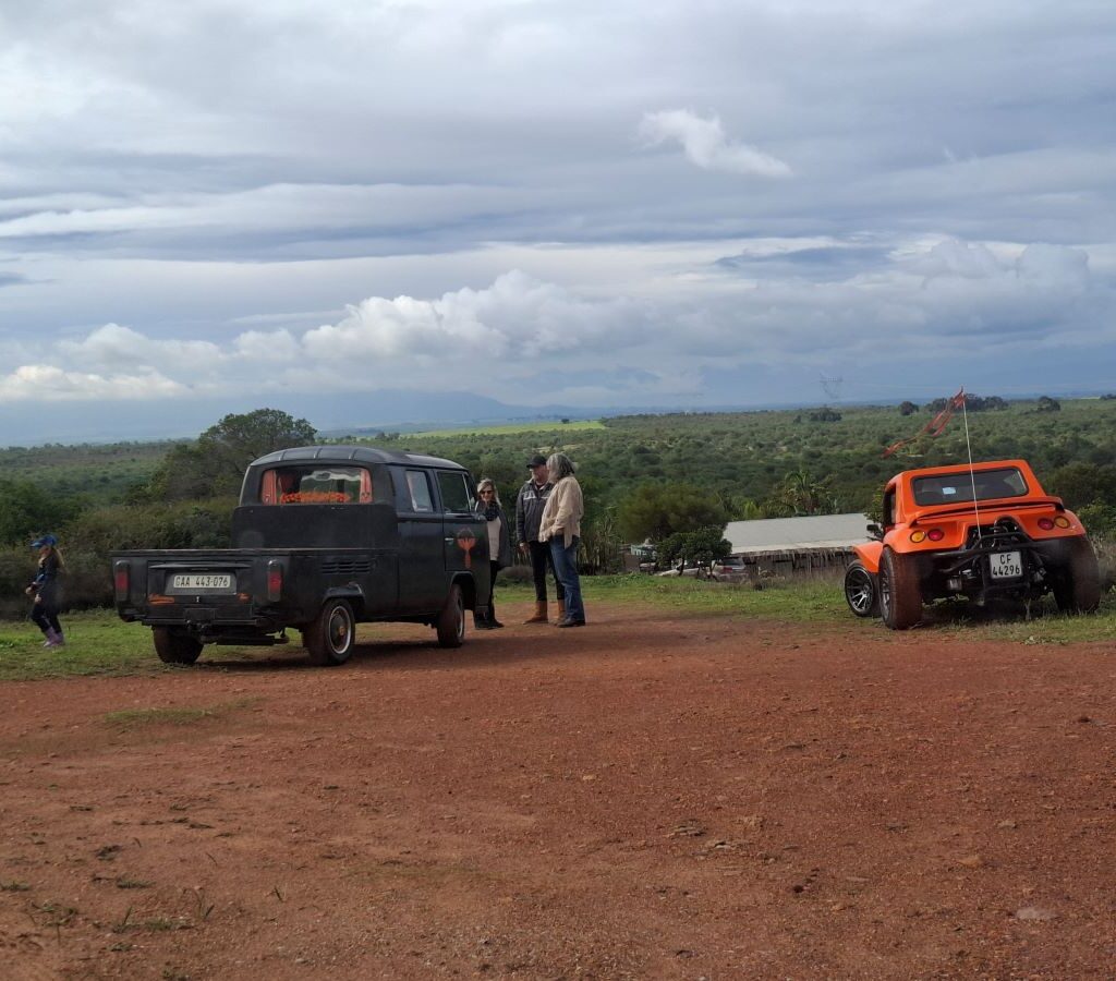 Brent in his orange VW air-cooled Salamander Beach Buggy and Tony in his VW air-cooled Kombi parked outside the secret gas station, chatting with John, the person who will guide them to "Mauritius" during Tony & Sue's Run.