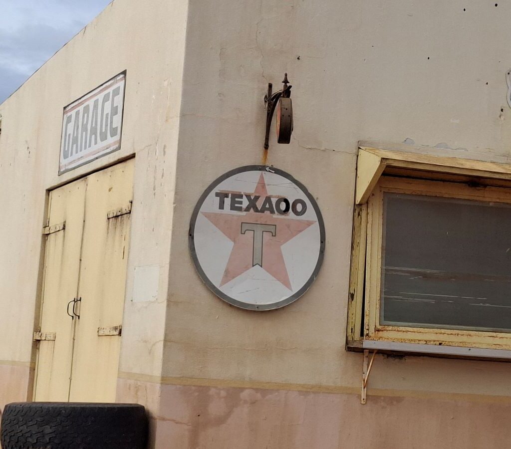 A vintage Texaco sign mounted on the wall of the old gas station visited by The Wild Buggers Beach Buggy Club during Tony & Sue's Run.