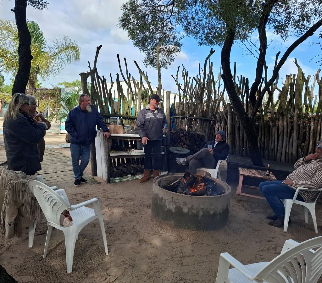 Wild Buggers club members relaxing and chatting around a warm fire at the "Mauritius" braai spot during Tony & Sue's Run.