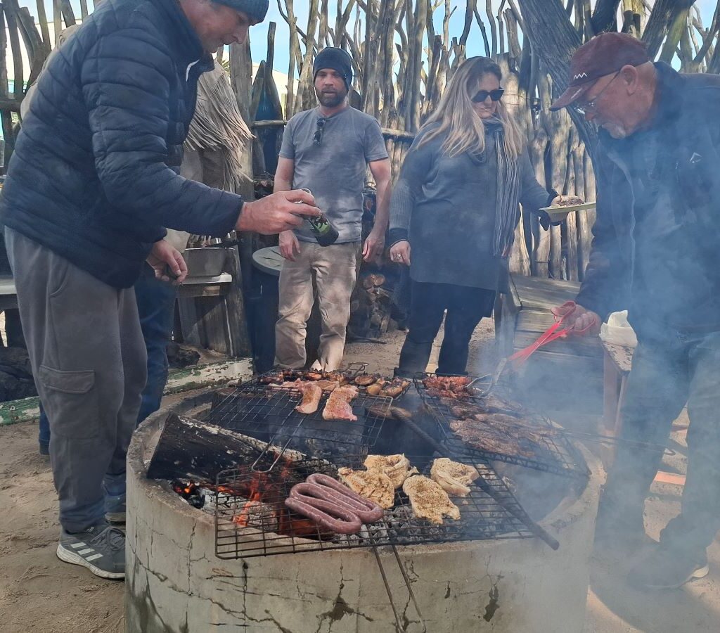 Wild Buggers club members preparing to put meat on the braai fire, signaling it's time to eat during Tony & Sue's Run.