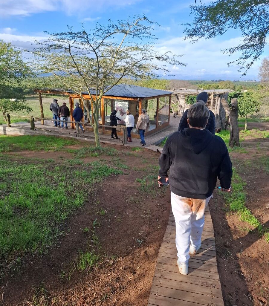 Wild Buggers club members walking down a path towards a house in the "African Savanna" themed area during Tony & Sue's Run.