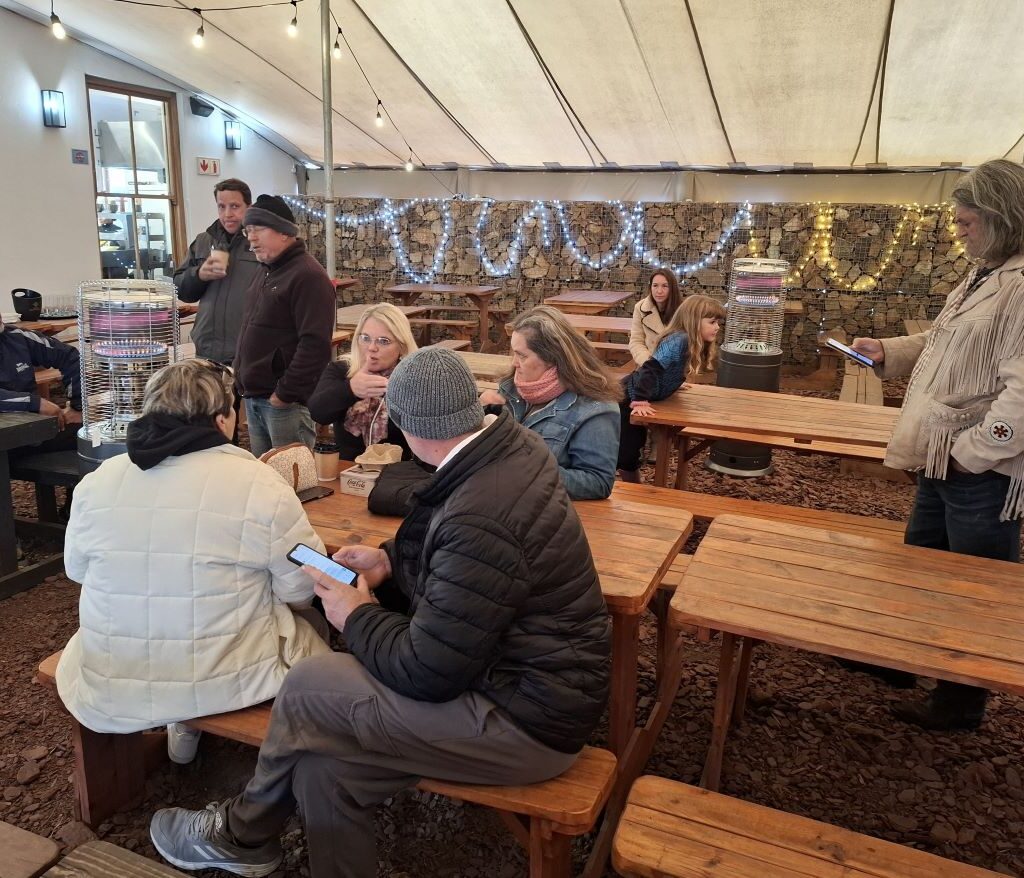 Wild Buggers club members relaxing inside Die Werf in Philadelphia, enjoying coffee and conversation during a break from their Beach Buggy run.
