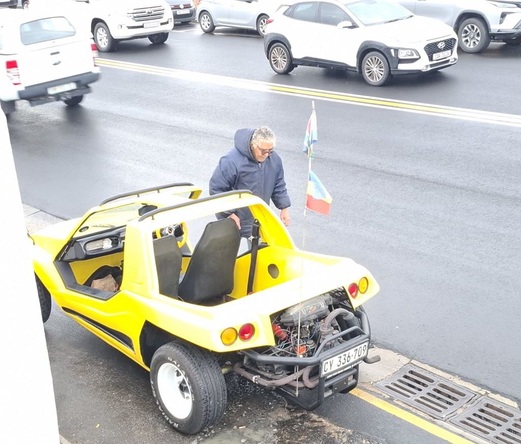 Fabian standing next to his yellow VW Air-Cooled Kango beach buggy at Wild Buggers 'Revving Up for the Lens' cruise