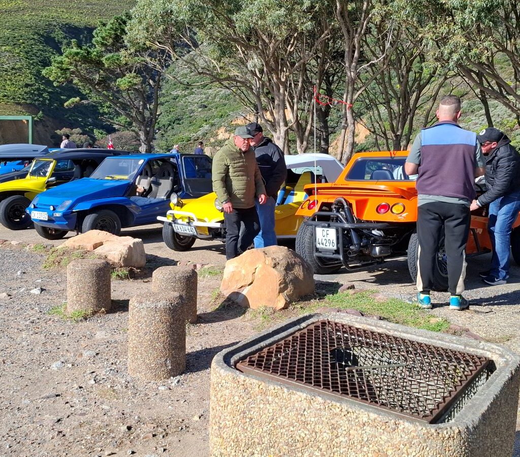 Wild Buggers club members chatting next to their beach buggies