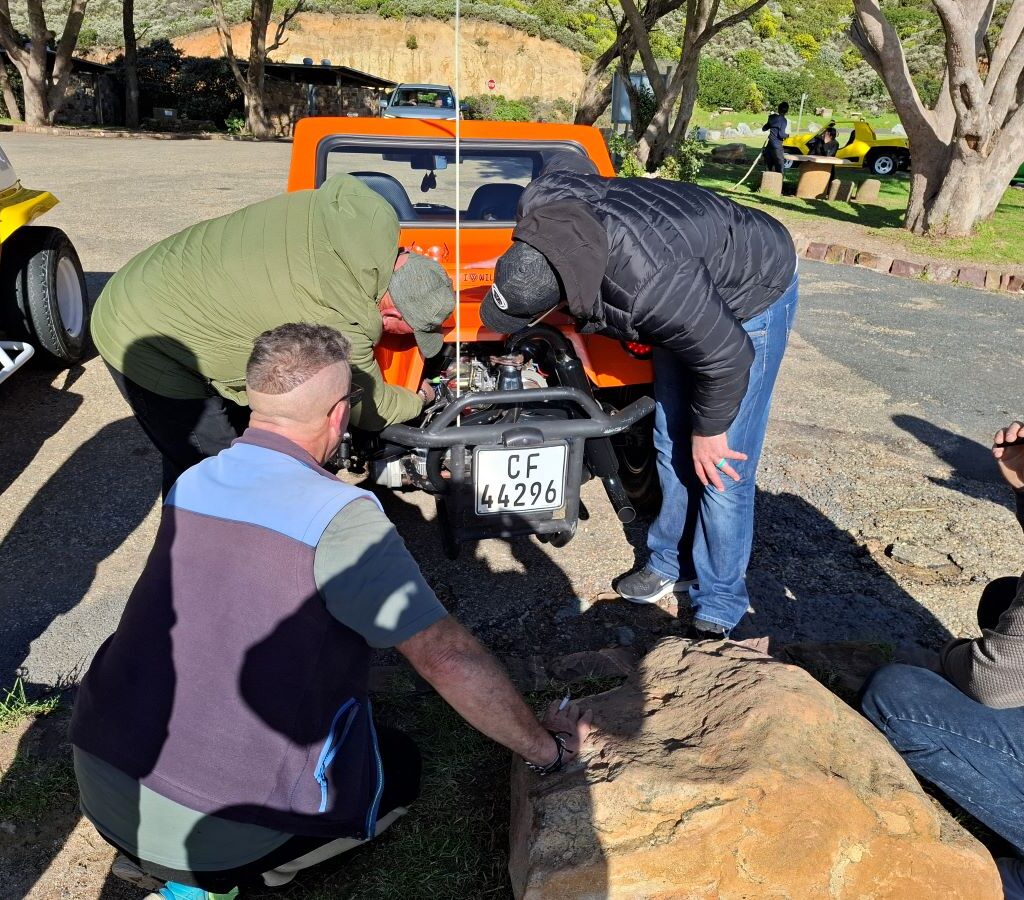 Wild Buggers club members still inspecting and troubleshooting beach buggy engine