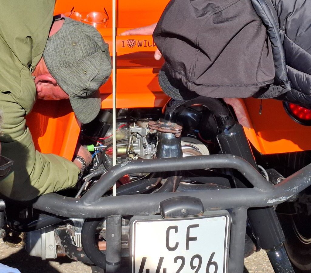 Close-up of a beach buggy engine repair, hands working on components