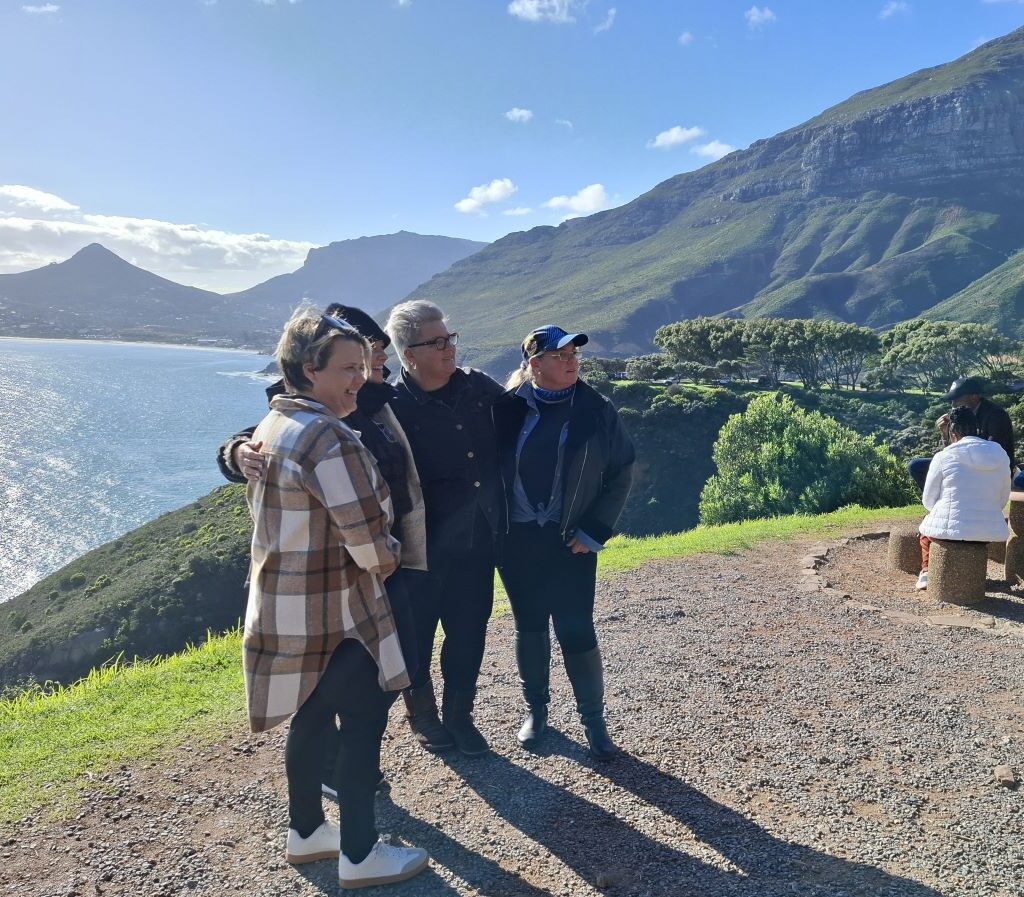 Wild Buggers ladies posing for a photo with ocean in background