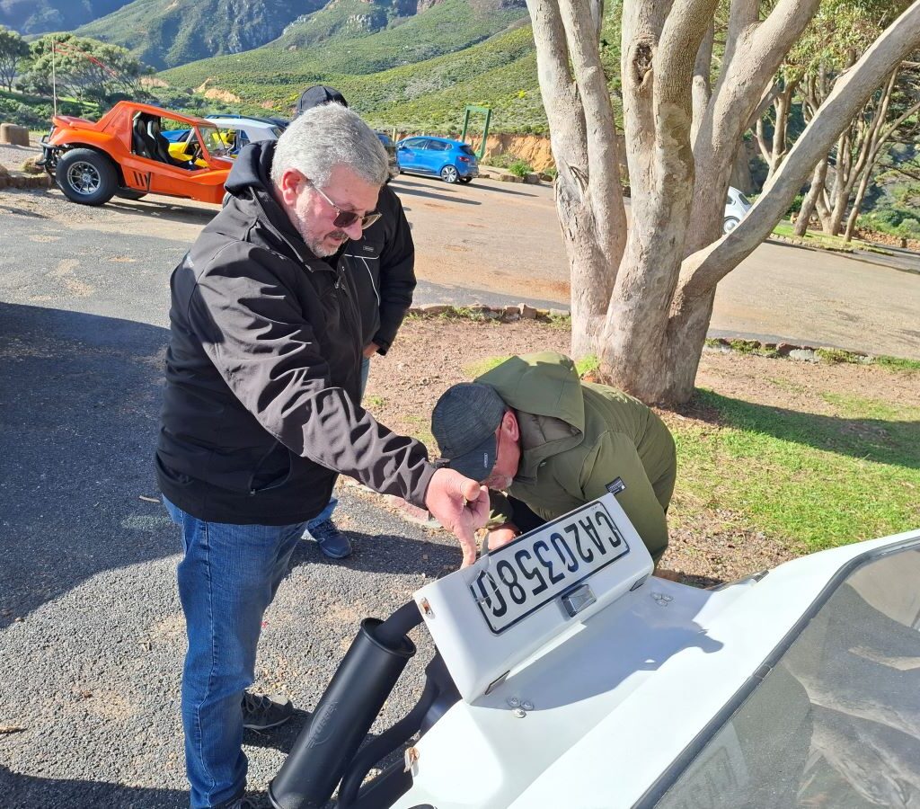 Nick showing new carburetor to Wild Buggers club members