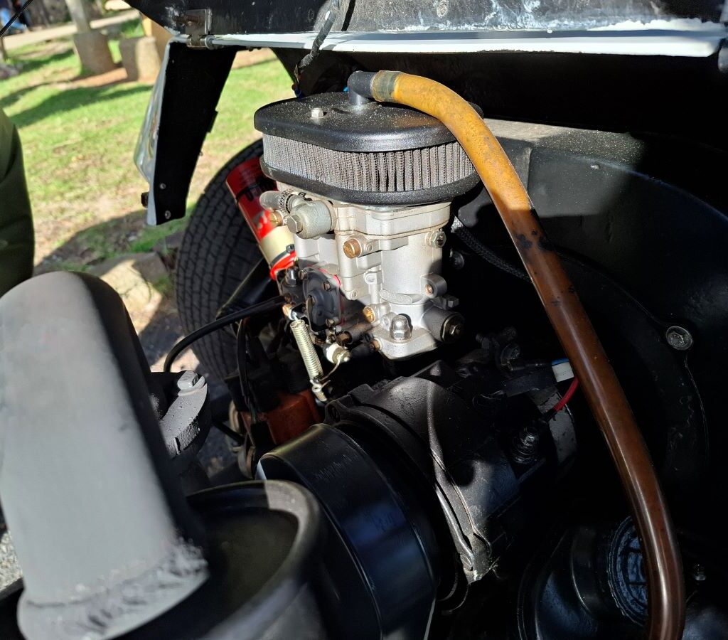 Close-up of a highly detailed, impressive carburetor on a VW air-cooled engine