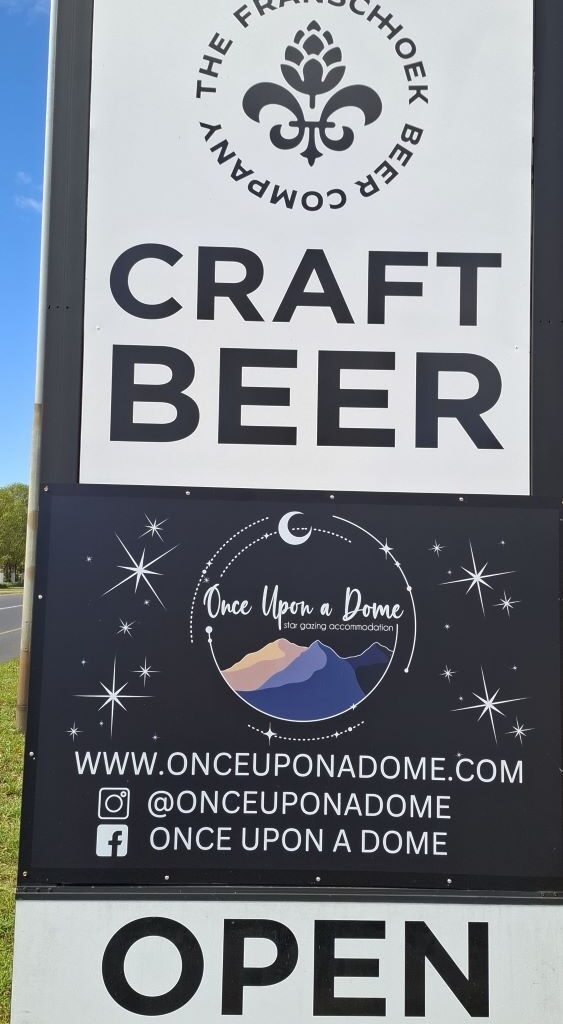 A photo of the official signboard for the Franschhoek Beer Company, a craft brewery, taken during a Wild Buggers club run.