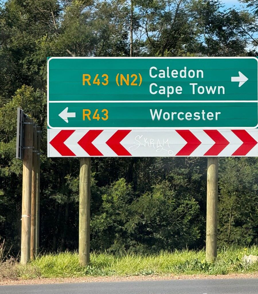 A photo of a road sign showing directions to Caledon, Cape Town, and Worcester, taken at a crossroads during a Wild Buggers club run.