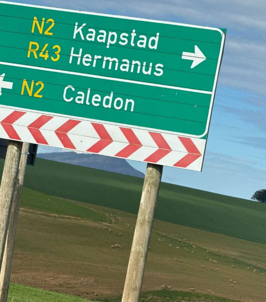 A photo of a road sign showing directions to Kaapstad, Hermanus, and Caledon, taken at a crossroads during a Wild Buggers club run.