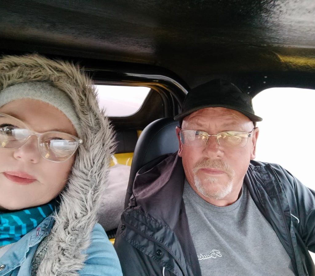 A selfie photo of Anthony and Michelle Jenkins smiling together in their beach buggy during a Wild Buggers club run.