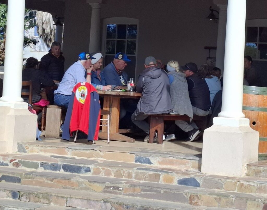 A photo of the Botrivier Hotel, a historic building with a welcoming entrance, where the Wild Buggers Beach Buggy Club has stopped for a well-earned lunch after their drive.