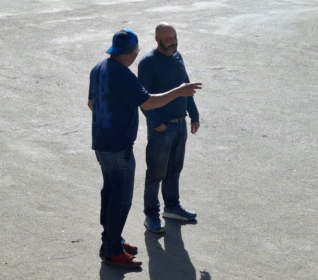 A photo of Wild Buggers' club members Fabian and Wiehann taking a smoke break together outside the Botrivier Hotel.