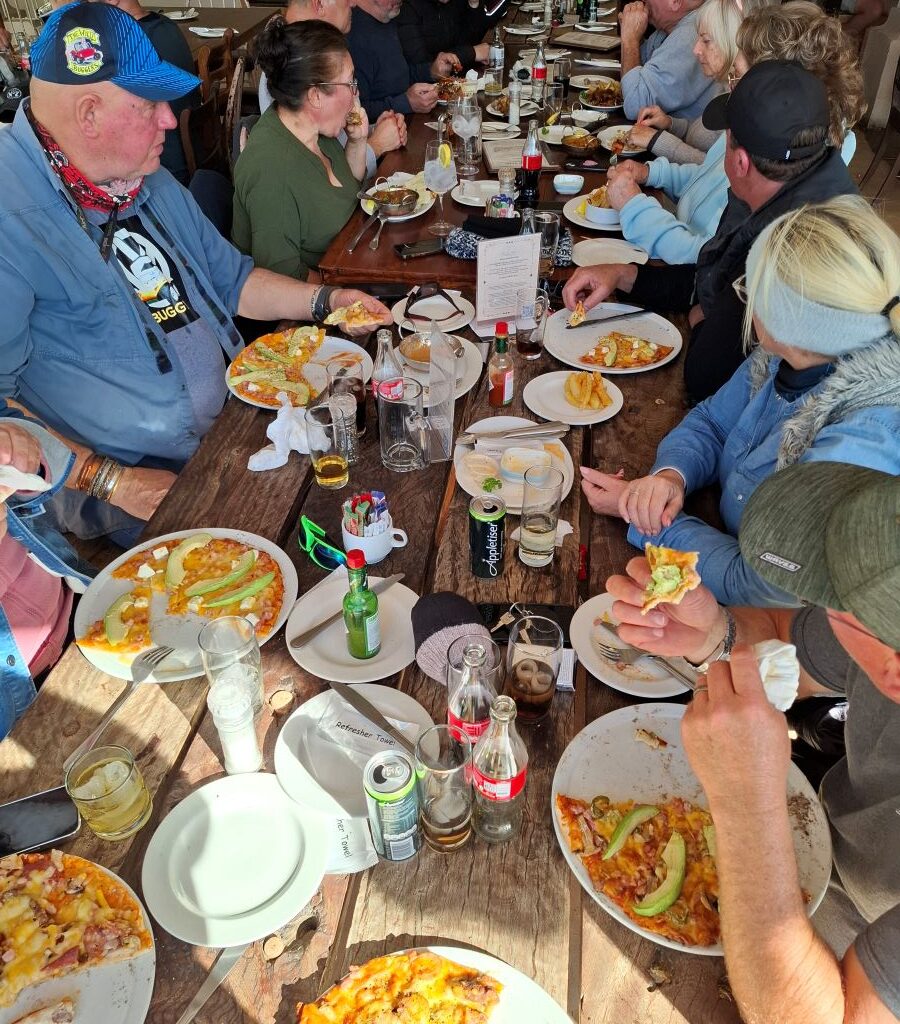 A photo of several plates of delicious food being served to Wild Buggers' club members sitting at a table at the Botrivier Hotel.
