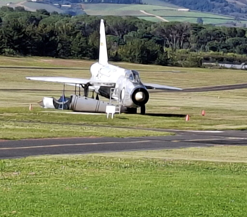 A close-up photo of a vintage fighter jet on display at the Stellenbosch Flying Club, a decommissioned military aircraft.