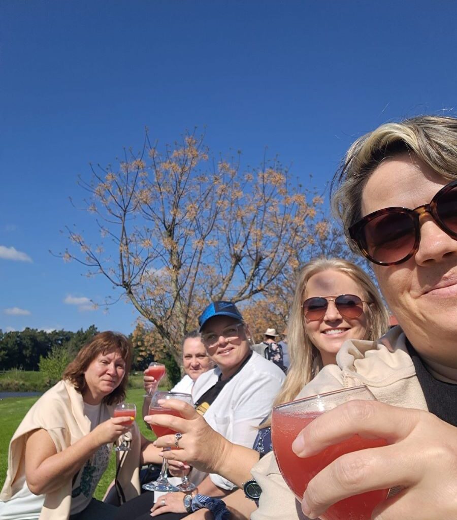 A joyful photo of the Wild Buggers "Ladybugs" (Sandra, Sam, Michelle, Mickey and Yolande raising their glasses in a toast, celebrating the fantastic weekend and their successful, hilarious camp games.
