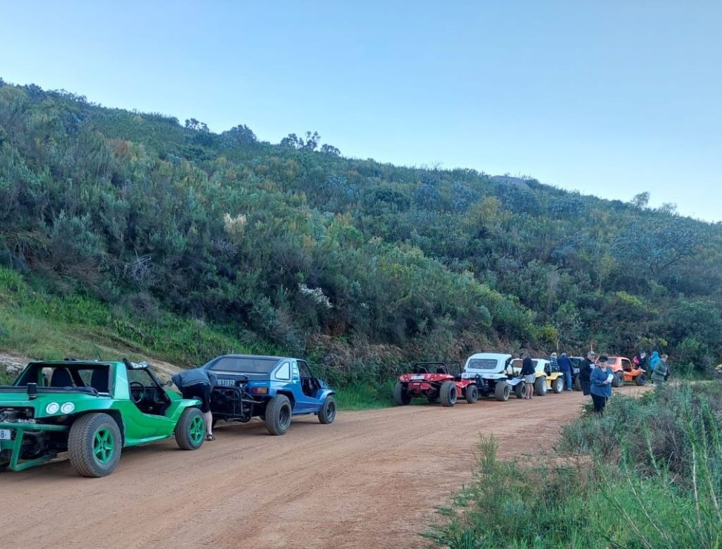 A warm, relaxed photo of the Wild Buggers members lingering at the beautiful Paarlberg sundowner spot, enjoying the view and one final, extended chat before reluctantly heading back to the campsite.