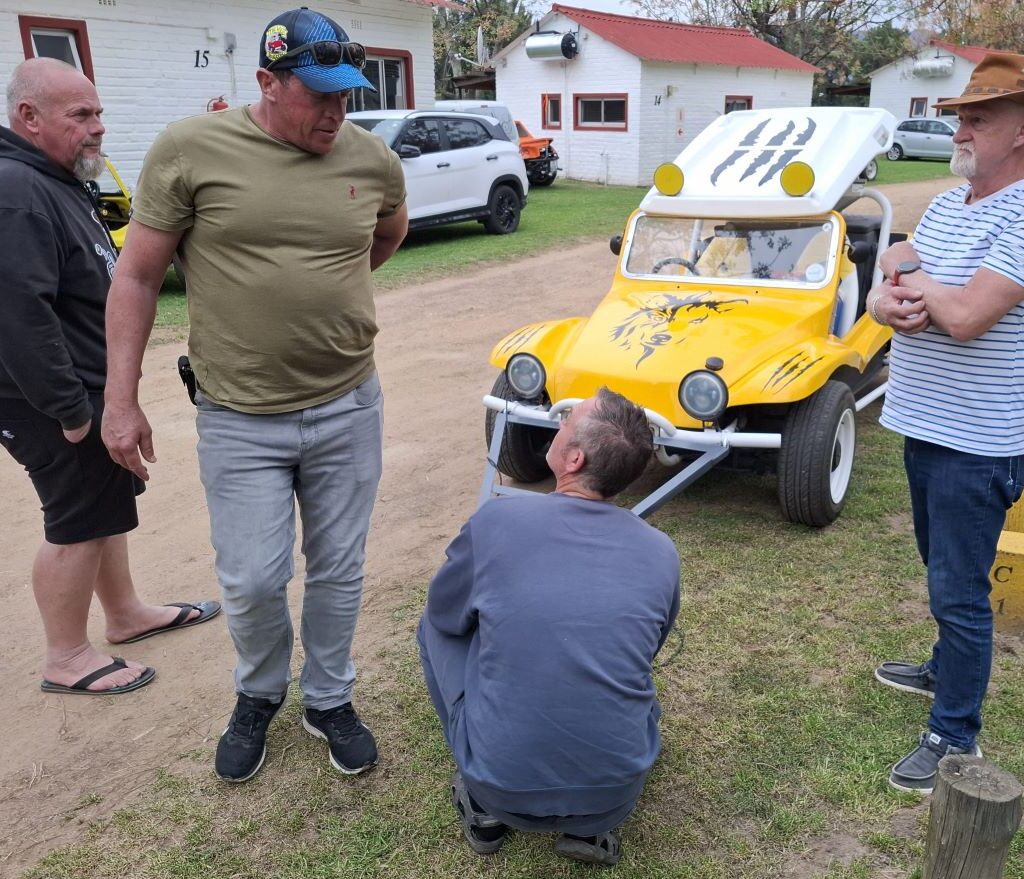A photo showing Anton H, Brent, Rhoodie, and Jacques standing ready at the Bergriver Resort camp, waiting patiently to help Chris hook his beach buggy to his motorhome for the drive home, highlighting the VW Family teamwork.