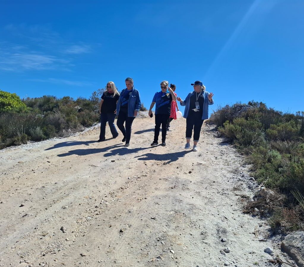 The last group of Wild Buggers members walk back to their cars from a scenic lookout point as others wait for them.
