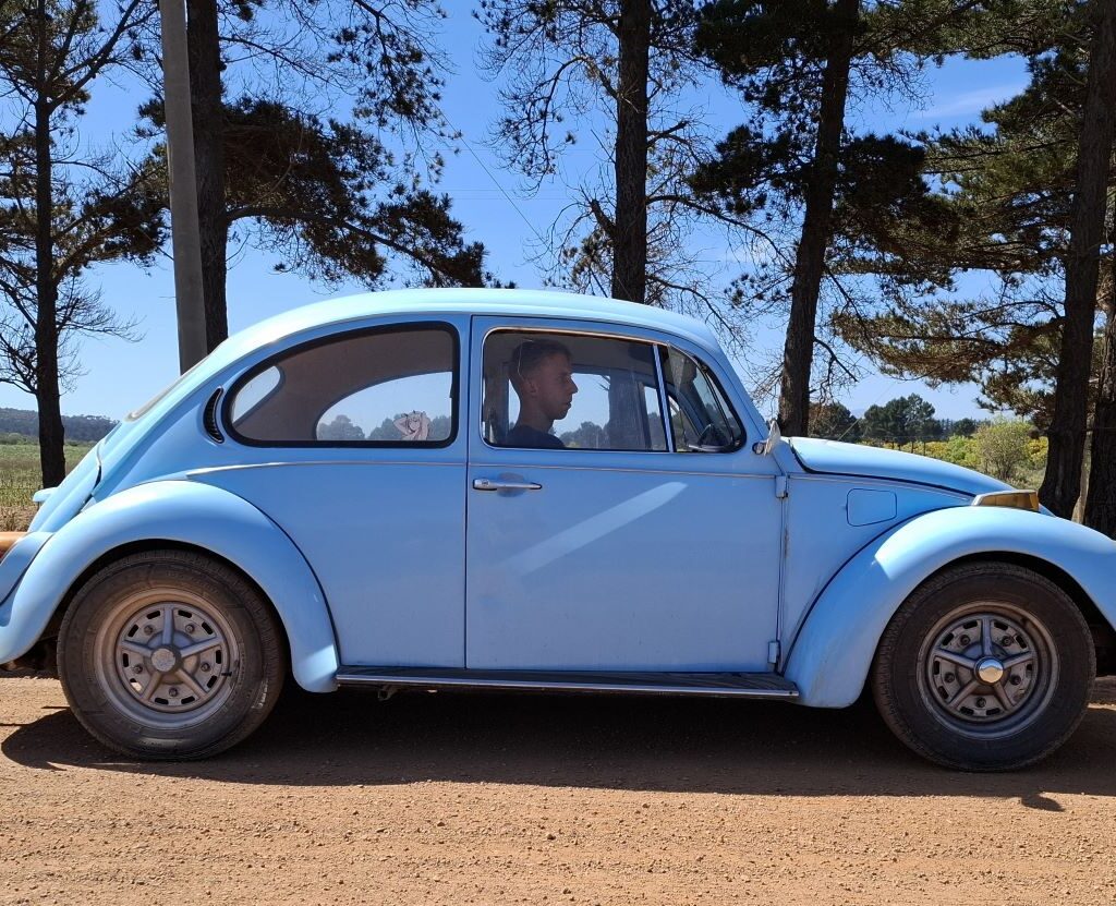 Kyle is pictured with his blue VW Beetle, which has a 1600cc VW air-cooled motor, on a quick roadside pitstop.