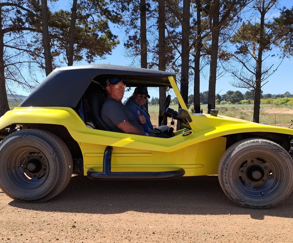 Anthony and Michelle are pictured sitting in their yellow VW Beach Buggy, 'Bumble Bee,' during a Wild Buggers run.