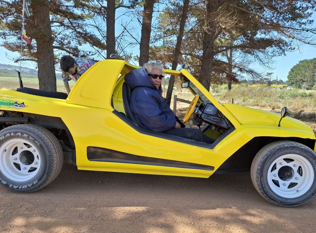 A photo of Fabian sitting comfortably in his VW Bug during a Wild Buggers event.