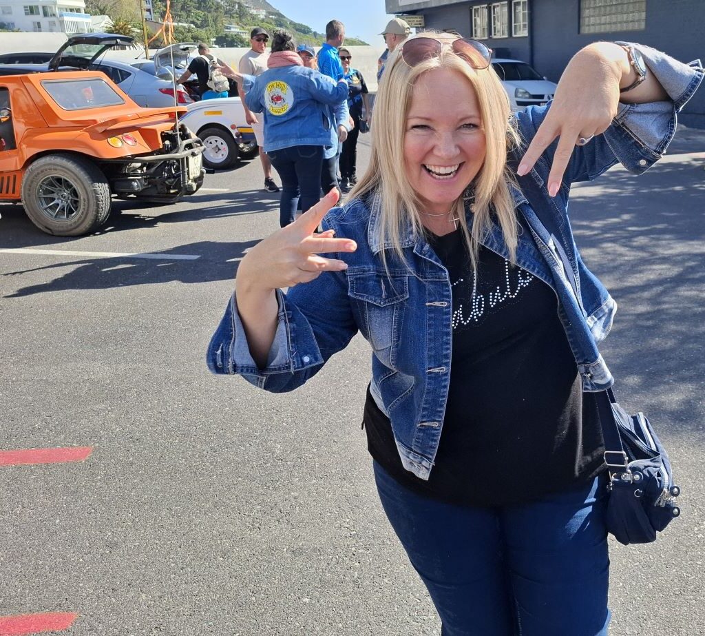 Sam poses for a fun photo while other Wild Buggers members and their Beach Buggy's are visible in the background.