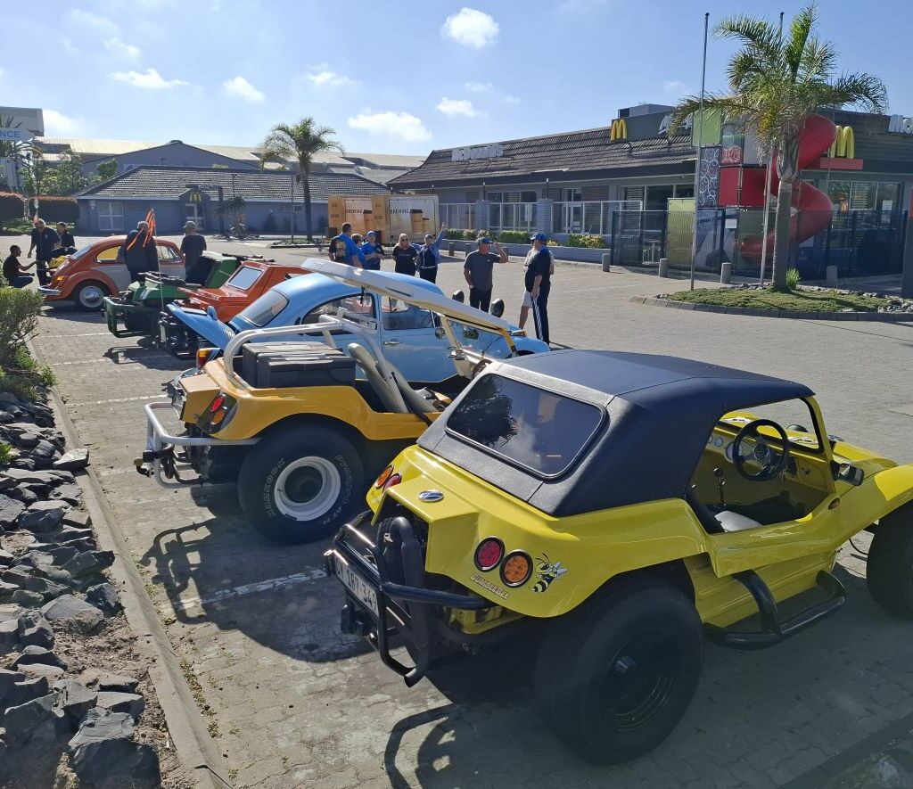 A lineup of various VW Air cooled vehicles, including Beach Buggys and a VW Beetle, gathered at the Wild Buggers meeting point.