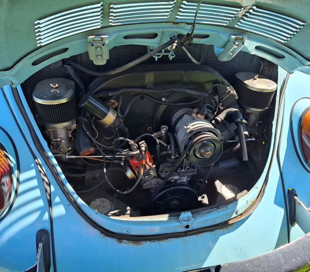 Kyle proudly shows off the VW air-cooled engine of his VW Beetle to other Wild Buggers members.
