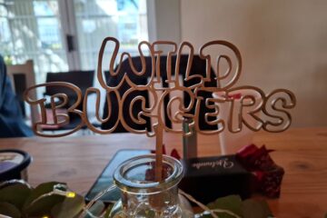 Close-up of the custom wooden "Wild Buggers" table decoration made by Sam.