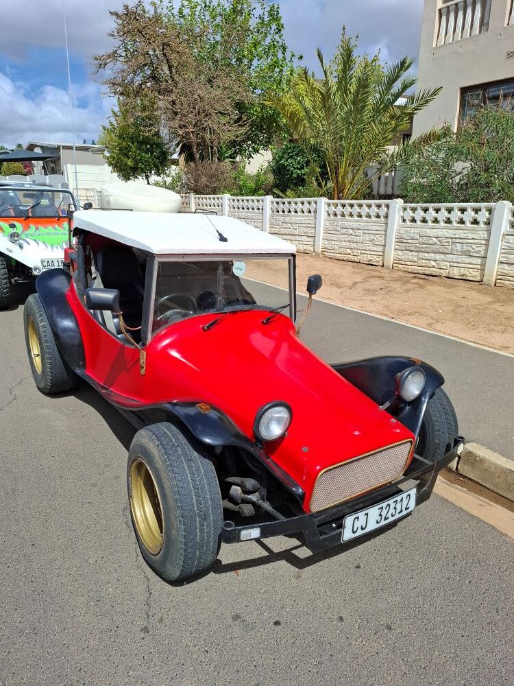 Hugo Kogelenberg’s custom red Coca-Cola themed T-Bug beach buggy featuring a 1600 VW air-cooled engine and gold rims.