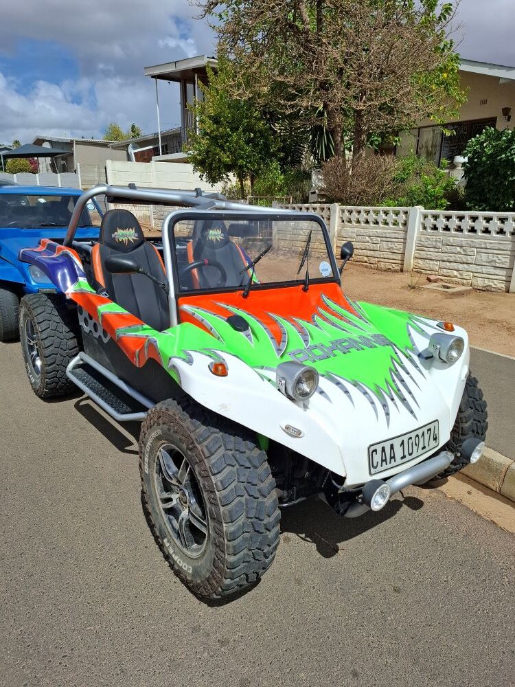 Roxanne, a custom white, green, and orange flame-painted VW beach buggy with a fuel-injected 1800 Golf engine and power steering.
