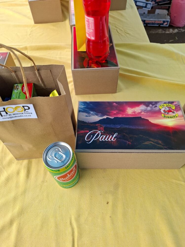 A personalized gift box for a resident named Paul, featuring a Cape Town sunset over Table Mountain and The Wild Buggers club logo.