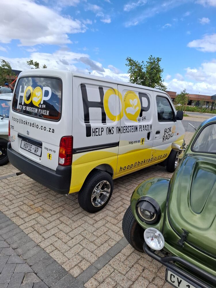 The Bok Radio "HOOP" project charity van parked among custom air-cooled VW Beach Buggies and Beetle vehicles at a Wild Buggers club event.